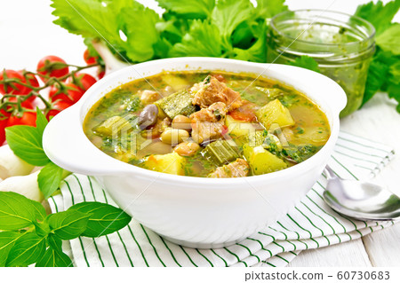 Soup with pisto sauce in bowl on white board 60730683