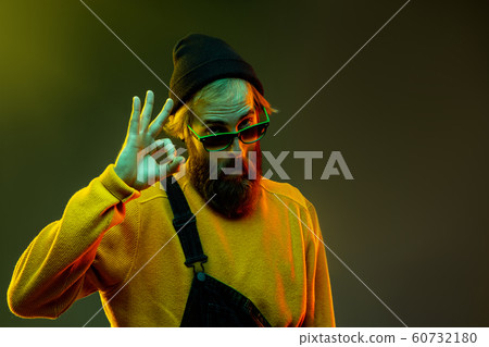 Caucasian man's portrait isolated on gradient studio background in neon light Caucasian man's portrait isolated on gradient studio background in neon light 60732180