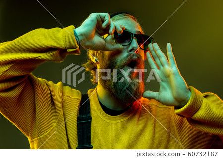 Caucasian man's portrait isolated on gradient studio background in neon light Caucasian man's portrait isolated on gradient studio background in neon light 60732187
