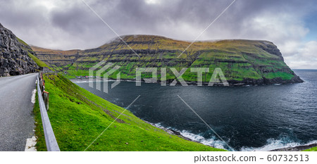 Super panorama of Tjornuvik village with colorful houses surrounded by green mountains in bay 60732513