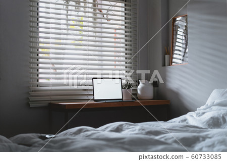 laptop with copy space empty screen and bed with laptop with copy space empty screen and bed with 60733085