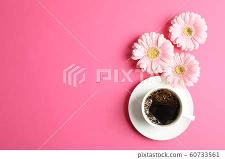 Beautiful pink gerbera flowers and cup of coffee Beautiful pink gerbera flowers and cup of coffee 60733561