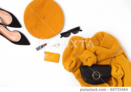 Woman outfit with yellow sweater, french beret, hand bag, sunglasses and other items on white background 60735464