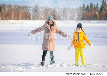 Family of mom and kid vacation on Christmas eve outdoors 60736596