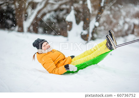 Portrait of little adorable girl in snow sunny winter day 60736752