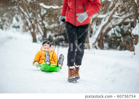 Family of dad and kids vacation on Christmas eve outdoors Family of dad and kids vacation on Christmas eve outdoors 60736754