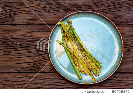 Top view delicious grilled asparagus on plate 60736871