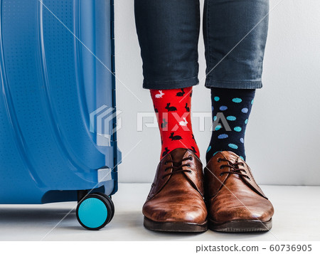 Stylish suitcase, men's legs and bright socks 60736905