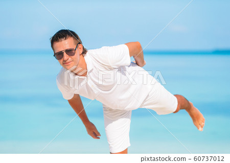 Young man on the beach having fun 60737012