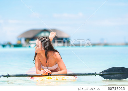 Active young woman on stand up paddle board 60737013