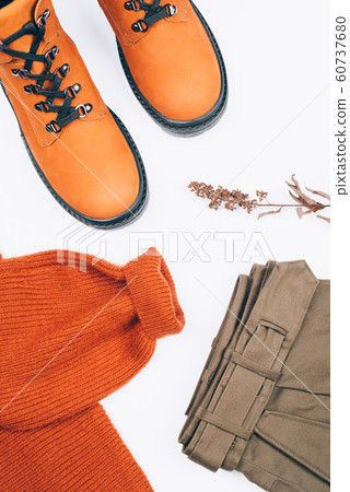 Warm clothes and boots on the table. Warm clothes and boots on the table. 60737680