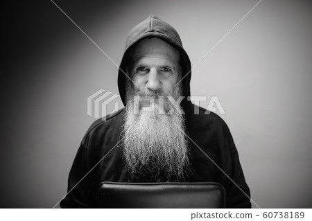 Portrait of mature bald bearded man wearing hoodie in black and white Portrait of mature bald bearded man wearing hoodie in black and white 60738189