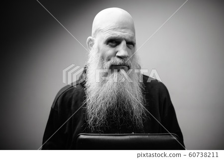 Portrait of mature bald bearded man with dramatic shot in black and white Portrait of mature bald bearded man with dramatic shot in black and white 60738211