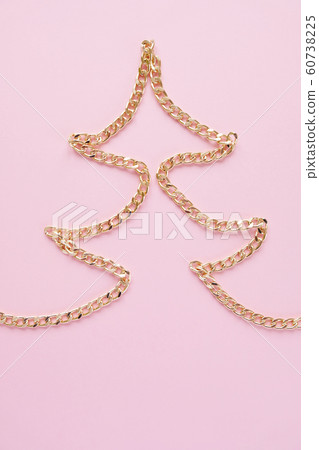a gold chain laid out in the shape of a x-mas tree a gold chain laid out in the shape of a x-mas tree 60738225