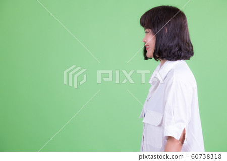 Profile view of happy Asian businesswoman smiling 60738318