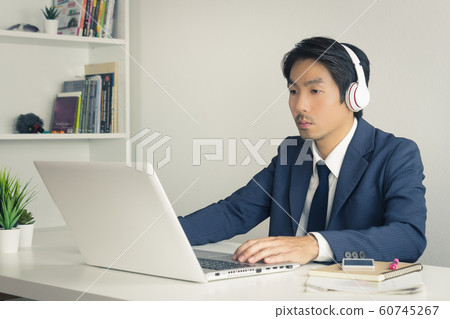 Asian Man Call Center Wear Headset Service Customer Via Internet in Vintage Tone Asian Man Call Center Wear Headset Service Customer Via Internet in Vintage Tone 60745267