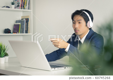 Asian Man Call Center Seriously Answer Customer Questions in Vintage Tone Asian Man Call Center Seriously Answer Customer Questions in Vintage Tone 60745268