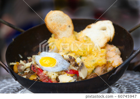 Argentine Creole steak cooked on the plow disk 60745947