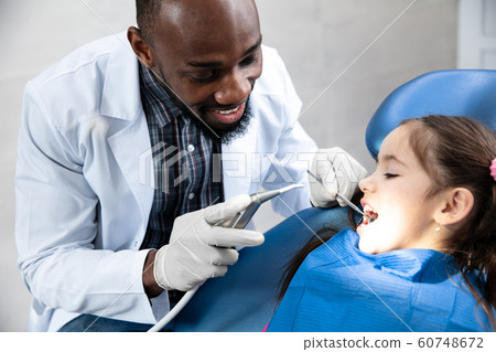 Young caucasian girl visiting dentist's office Young caucasian girl visiting dentist's office 60748672