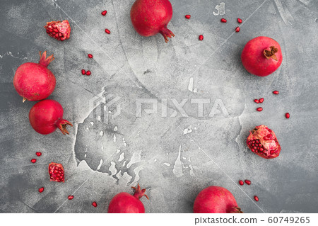 Pomegranate with seeds on dark background. Food frame background. Flat lay, top view Pomegranate with seeds on dark background. Food frame background. Flat lay, top view 60749265