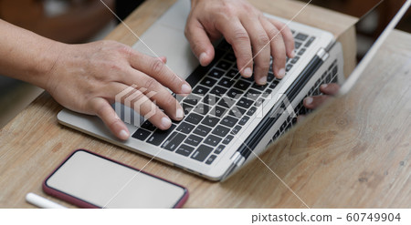 Cropped shot of man working on his project while 60749904