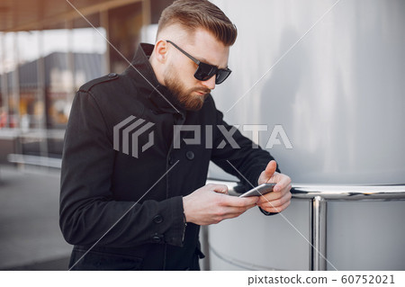 Handsome businesman in a summer city 60752021