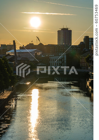 Sunset over the river and city buildings 60753469