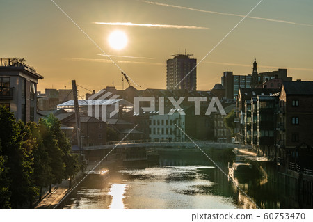 Sunset over the river and city buildings 60753470