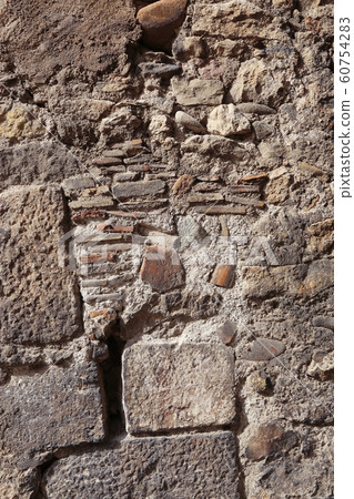 Texture of an old wall of stones and bricks 60754283