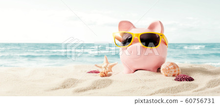 Piggy bank on vacation. Finance and travel concept Piggy bank on vacation. Finance and travel concept 60756731