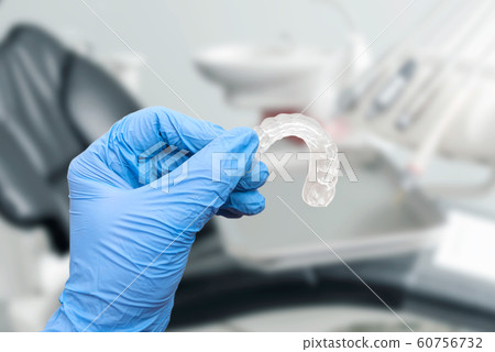 Hand in glove holding invisible aligner Hand in glove holding invisible aligner 60756732