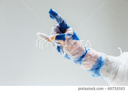 Big plastic hand made of garbage isolated on white studio background 60758383