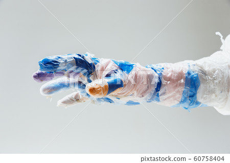 Big plastic hand made of garbage isolated on white studio background 60758404