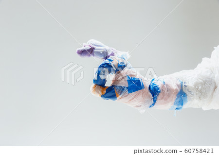 Big plastic hand made of garbage isolated on white studio background 60758421