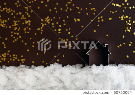 Miniature house on snow and a dark background with Miniature house on snow and a dark background with 60760094