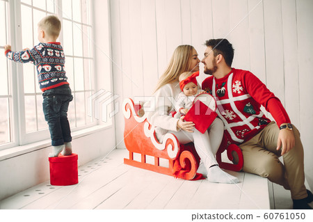 Family sitting at home with christmas gifts Family sitting at home with christmas gifts 60761050
