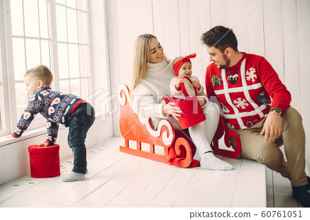 Family sitting at home with christmas gifts Family sitting at home with christmas gifts 60761051