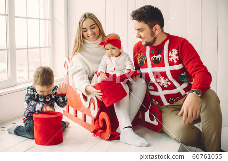 Family sitting at home with christmas gifts Family sitting at home with christmas gifts 60761055