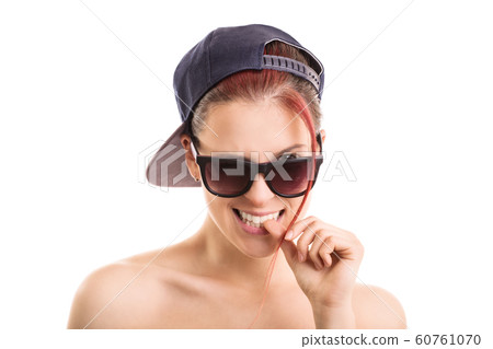 Young girl wearing sunglasses and a snapback cap Young girl wearing sunglasses and a snapback cap 60761070