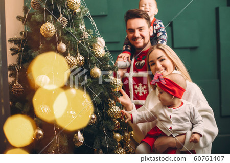 Family at home near christmas tree 60761407