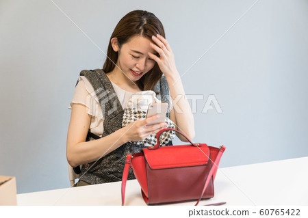 A woman shooting a bag 60765422