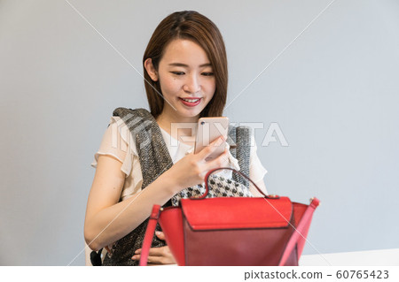 A woman shooting a bag 60765423