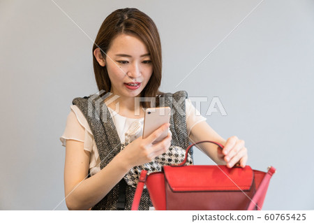 A woman shooting a bag 60765425