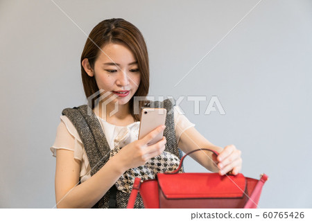 A woman shooting a bag 60765426