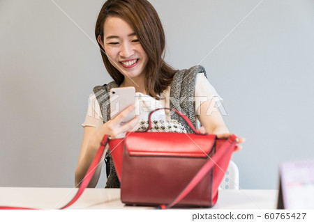 A woman shooting a bag 60765427