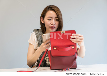 A woman shooting a bag 60765437