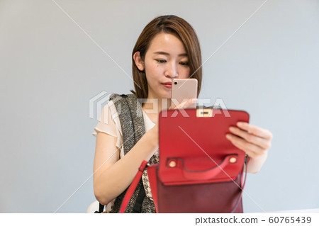 A woman shooting a bag 60765439