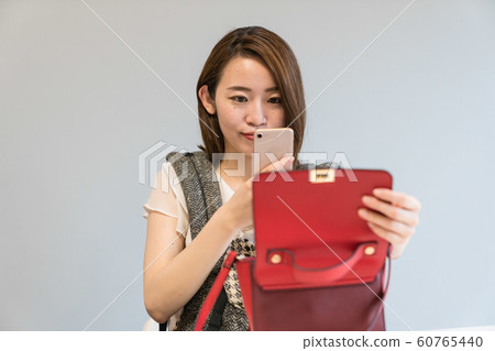 A woman shooting a bag 60765440