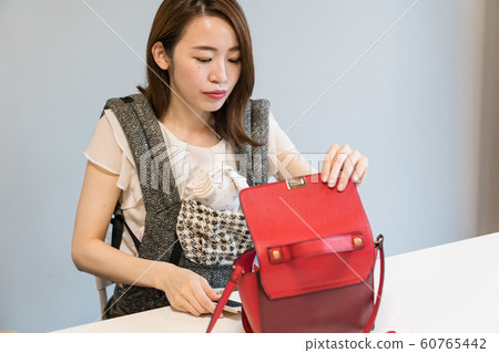 A woman shooting a bag 60765442