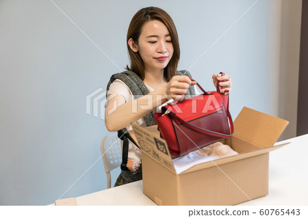 A woman shooting a bag 60765443